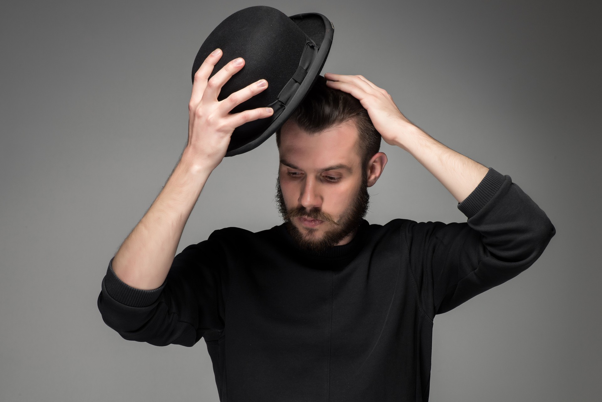 Young man raising his hat  in respect and admiration for