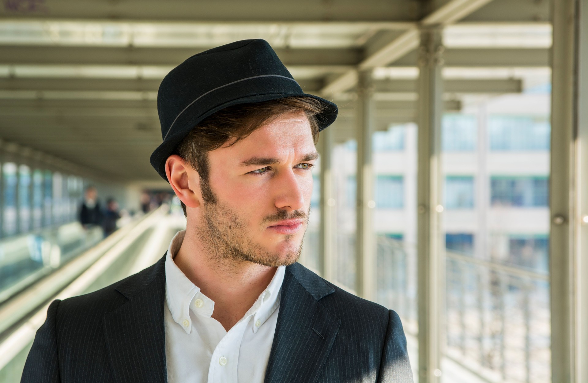 Man Wearing Hat and Looking Out Window