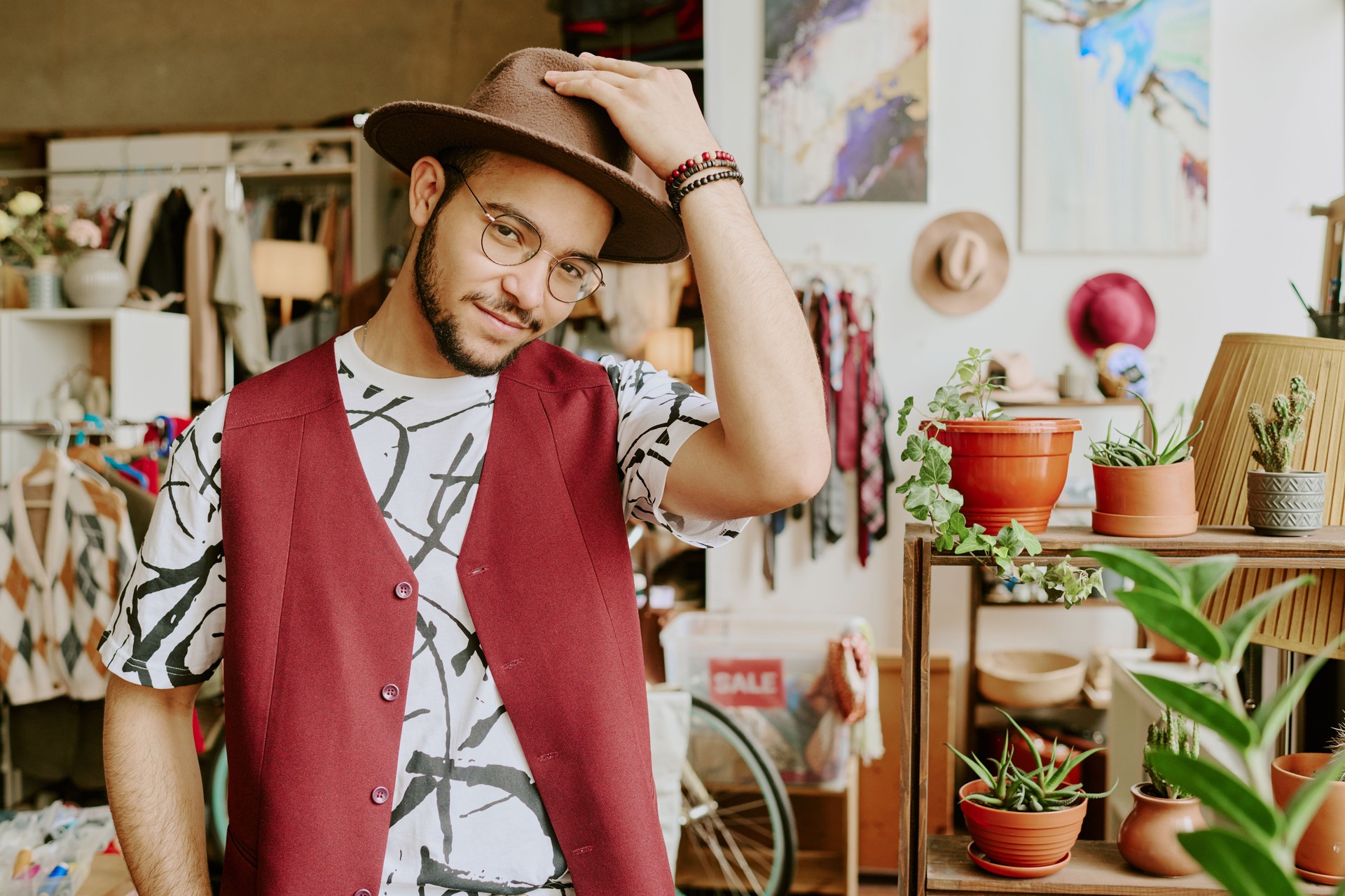 Adjusting Hat in Quaint Boutique Store Setting